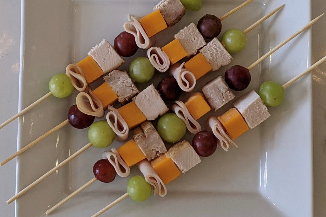 School lunch skewers made with fruits and turkey ham.