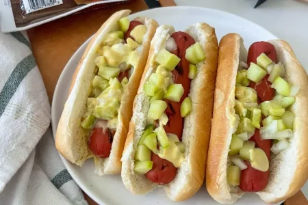 Eve-Mayrands-Pickled-Cucumber-and-Truffle-Mustard-Turkey-Franks-1-819x1024 Pickled cucumber and truffle mustard turkey franks placed on a wooden tray.