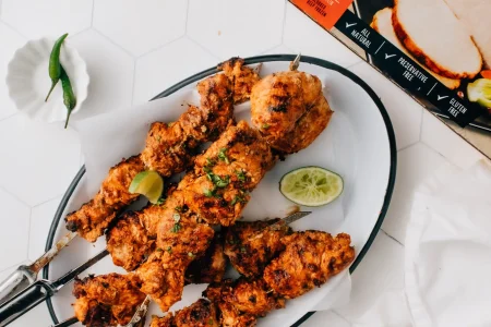 Butterball-Tandoori-Turkey-Kebabs-1-3-scaled Butterball tandoori turkey kebabs with lemon on the side placed in a tray.