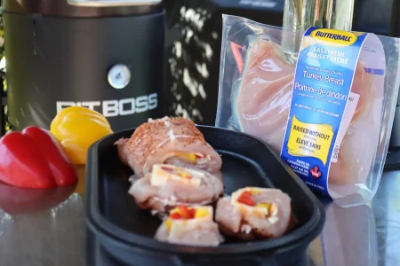 A tray of food on a table next to a bag of food, ready to be served.