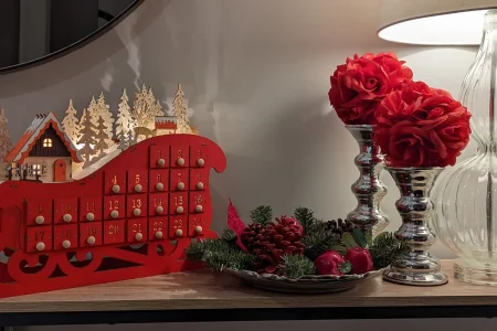 Traditional red sleigh with holiday decorations.