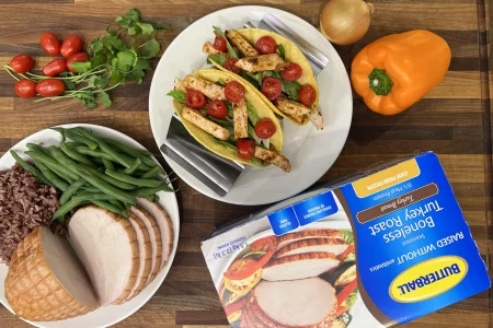 Butterball turkey breast roast tacos garnished with tomatoes and lettuce.