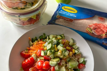 Turkey Bacon salad with tomatoes and cucumber in a bowl.