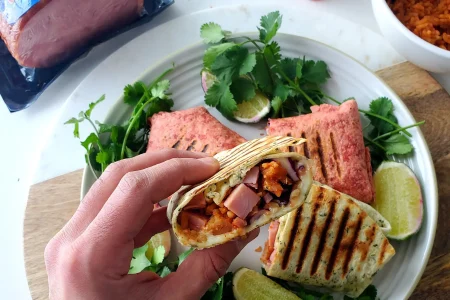 Turkey bacon wrap with cilantro and lemon placed on the table.