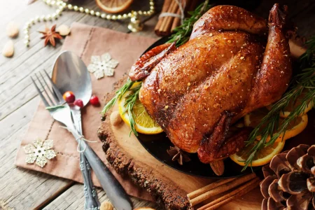 AdobeStock_180912098-scaled Christmas whole turkey rubbed with spice with lemon and cherries.