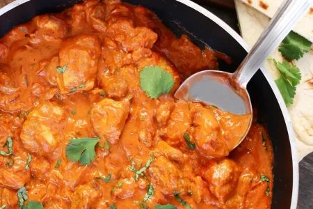 Turkey-Tikka-Masala-Online-Consult-Influencer-for-Print-and-Broadcast-min-scaled Turkey tikka masala served in a pan with a side of naan bread and white rice.