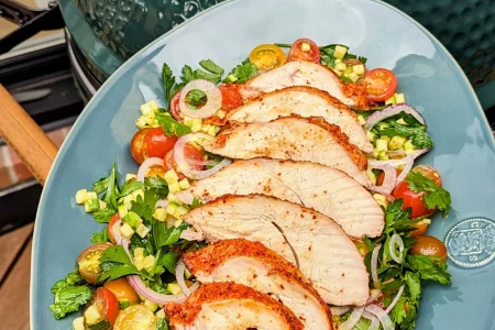 Image of a person holding a plate of turkey and salad for a healthy meal.